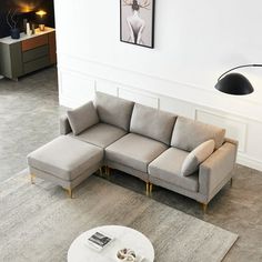 a living room with a sectional couch and coffee table