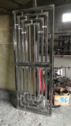 an old jail cell door is open on the ground