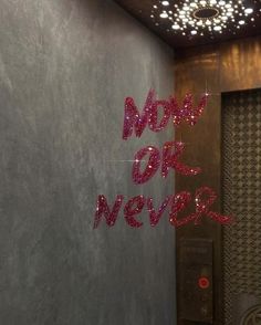 there is a sign that says now or never on the wall