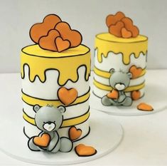 two cakes with teddy bears on them sitting next to each other in front of one another