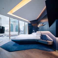 a bedroom with a large bed in the middle and a tv on top of it