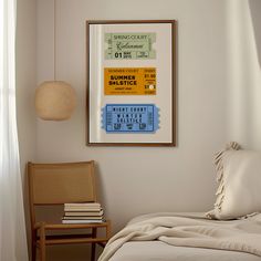 a bedroom with a poster hanging on the wall next to a bed and chair in front of it