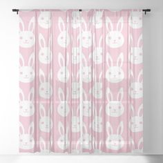 a pink curtain with white rabbits on it