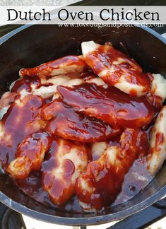 some chicken is cooking in a skillet on the stove with sauce and ketchup