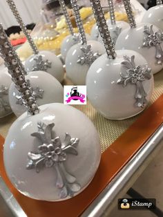 some white balls with silver decorations on them