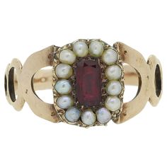 Here we have a charming cluster ring originally dating back to the Georgian period. A single elongated oval faceted ruby possessing a rich red colour tone sits at the centre of the face. This principal stone is then framed by a single row of round shaped pearls around the outer edge. A trio of graduating openings make up the shoulders and lead towards the face before the piece is finished with a roped style shank.  Condition: Used (Good) Weight: 2.7 grams Size: P (56.5) Face Dimensions: 11mm x 8 Ruby And Pearl, Vintage Cluster Ring, Face Dimensions, Pearl Cluster Ring, Georgian Ring, Georgian Jewelry, Elongated Oval, Shiny Objects, Pearl Cluster