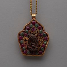 Jambhala Pendant - Exquisite Gold Plated Copper with Ruby & Emerald Disclaimer: Please note that the locket you've ordered does not include the chain/necklace. However, we have some special chains/necklaces available to complement your locket perfectly. If you're interested in our chain/necklace options, please don't hesitate to send us a message for more details. Thank you for choosing us! About our Locket: Embrace the spiritual grace of our exquisitely created copper body Jambhala pendant, whi Wealth And Abundance, Ruby Emerald, Filigree Design, Chains Necklaces, Emerald Stone, Locket Necklace, Meaningful Gifts, Precious Metals, Nepal