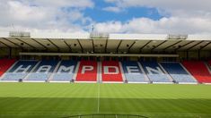 an empty soccer stadium with the name hampdden painted on it's side