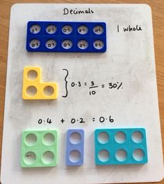 three different colored legos on top of a white board