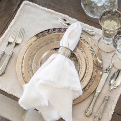 a place setting with silverware and napkins