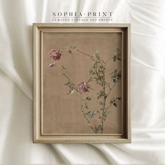 an image of some flowers in a frame on a white bed sheet with the words sophia print