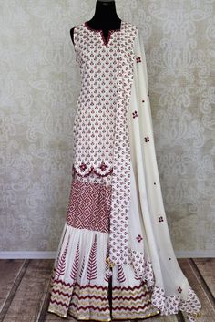 Buy beautiful white Kalamkari cotton sharara suit online in USA with mirror work. Get set to dazzle on festive occasions in this exquisite designer suits, Anarkali dress, sharara suits, salwar suits, palazzo suits from Pure Elegance Indian fashion store in USA.-full view Designer Cotton White Sharara, Designer White Cotton Sharara, Bollywood Style Off White Palazzo Set With Chikankari Embroidery, Cream Chanderi Sharara With Mirror Work, White Mirror Work Kurta For Diwali, Diwali Off White Palazzo Set With Chikankari Embroidery, White Palazzo Set With Resham Embroidery And Straight Kurta, White Chanderi Sharara With Dupatta, White Kurta With Mirror Work For Diwali