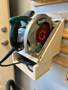 a makit circular saw is being used to cut wood with a cordless jig