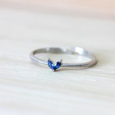 Our Dainty Silver Heart Ring is a single band sterling silver ring with blue zirconias on top. It is also adjustable from the bottom so you can easily fit it to your measurements. This dainty, tiny, minimalist-style ring can be worn daily as well as on special occasions.