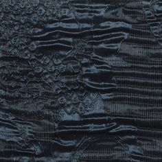 an old piece of cloth that has been stitched together and is blue with black stripes