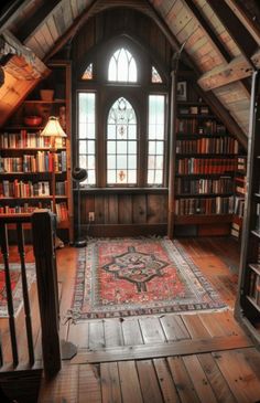 a room filled with lots of books on top of a wooden floor next to a window