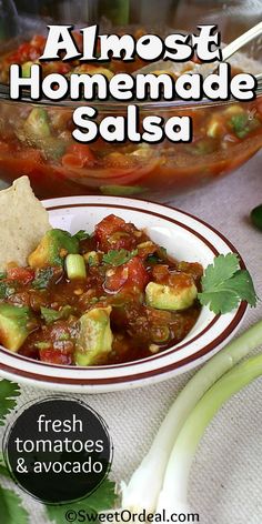 a bowl of salsa with tortilla chips and cilantro on the side