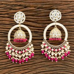 Hot Pink Polki Kundan Chandbali Earrings. Length: 5 inch Width: 2 inch Handcrafted pair of earrings. Gives a traditional look. Can be worn for engagement and wedding parties.   Indulge in it or gift it and watch the compliments flow! It is advisable to store jewelry in a zip lock pouch (air tight pouch), keep away from water perfume and other chemicals and clean it with soft cloth. FREE SHIPPING!! Chandbali Earrings With Latkans For Eid, Round Earrings With Latkans For Diwali, Traditional White Dangle Jhumkas, Round Earrings For Navratri Festival, Round Earrings For Navratri Festivities, White Latkans Earrings For Navratri, Bollywood Style Festive Jhumkas Dangle Earrings, Bollywood Earrings For Celebration And Navratri, Traditional Heavy Hoop Earrings For Diwali