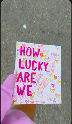 someone holding up a card that says how lucky are we