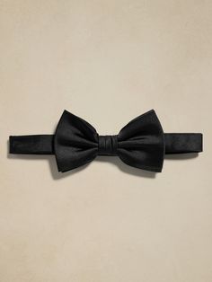 We crafted this bow-tie from stunning silk satin, a traditional and timeless choice.  It arrives pre-tied, so there's no need to worry about tying the perfect knot.  Bow tie is pre-tied.  Adjustable slider strap with hook fastening. Pre-tied Satin Bow For Black Tie Events, Classic Pre-tied Satin Bow Tie, Tuxedo Bow Tie With Satin Bow For Black-tie Events, Classic Bow Tie For Black-tie Events, Classic Adjustable Bow Tie For Black-tie Events, Detachable Bow For Black-tie Events, Silk Party Ties, Tuxedo Bow Tie For Black-tie Events, Tuxedo Bow For Black-tie Events