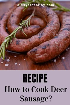 some sausages on a wooden table with rosemary sprigs in the middle and text that reads recipe how to cook deer sausage?