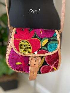 Embroidered Genuine Leather Bag Dare to be bold and adventurous with our Handcrafted Leather Purse, carefully crafted in Chiapas Mexico by our skilled partners. Made with genuine leather and adorned with exquisite embroidery, this purse exudes elegance and sophistication. The 7"x8" dimensions provide ample space for your essentials, while the 8 inch strap allows for easy and comfortable wear. Elevate your look and add a touch of Mexican flair to your outfit with this unique and striking accessor Leather Bag With Multicolor Embroidery For Everyday Use, Embroidered Crossbody Satchel For Daily Use, Leather Bag With Floral Embroidery And Rectangular Shape, Embroidered Satchel Shoulder Bag, Rectangular Leather Bag With Floral Embroidery, Embroidered Leather Crossbody Bag, Floral Embroidered Satchel Shoulder Bag For Travel, Leather Shoulder Bag With Floral Embroidery For Travel, Embroidered Leather Rectangular Shoulder Bag