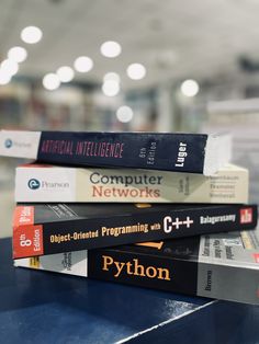 a stack of books sitting on top of a blue table