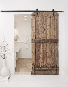 an open door leading to a bathroom and bedroom