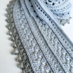 a crocheted scarf is shown on a white surface