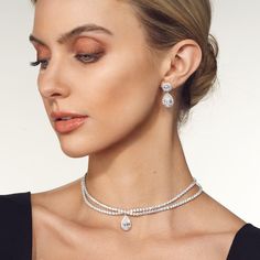 The Teardrop Crossover Diamond Choker Necklace is an exquisite piece of jewelry that exudes elegance and sophistication. Crafted with meticulous attention to detail, this necklace features a unique design that captivates the eye. At the center of the choker lies a breathtaking pear or teardrop-shaped diamond delicately nestled in a crossover pattern. The diamond, meticulously chosen for its exceptional quality and brilliance, glisten and sparkle as they catch the light, creating a dazzling displ Formal Fine Jewelry Necklaces With Jewels, Exquisite White Gold Jeweled Necklaces, Formal Diamond Necklace With Jewels, Exquisite Pendant Jewelry For Formal Occasions, Exquisite Formal Pendant Jewelry, Classic White Gold Necklaces With Jewels, Evening White Gold Necklaces With Jewels, Fine Jewelry Necklace With Jewels For Evening, Fine Jewelry Necklaces With Jewels For Evening