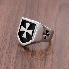 Presenting this Knights Templar Commandery Ring in durable stainless steel, showcasing a bold black and silver design. This emblematic ring symbolizes the strength and heritage of the esteemed order, a striking statement of commitment and honor. Metals Type: Stainless Steel Surface Width: 20mm Ring Face: 1.9cm*1.64cm Weight: 13g We ship worldwide to 185 countries! Please allow 1-2 business weeks for your order to arrive. Iron Cross Ring, Silver Knight, Iron Cross, Steel Gifts, Silver Design, German Army, Cross Ring, Bold Black, Black And Silver