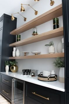 the shelves in this kitchen are lined with vases