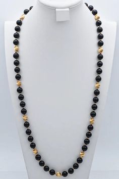 Embrace sophistication with our Vintage 14K Yellow Gold Black Onyx Beaded Strand Necklace. This 35-inch stunner exudes classic charm, making a bold statement in any ensemble. Elevate your style game with this exquisite piece! #VintageJewelry #OnyxNecklace #GoldBeadedStrand Elegant Polished Black Beads, Elegant Black Polished Beads, Luxury Black Polished Beads Jewelry, Luxury Black Jewelry With Polished Beads, Luxury Black Polished Bead Jewelry, Luxury Black Necklace With Polished Beads, Onyx Necklaces With Polished Beads, Onyx Necklaces With Polished Round Beads, Polished Onyx Bead Necklaces