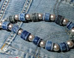 a pair of bracelets made out of jeans with pearls and beads on the clasp