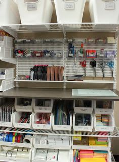 the shelves are organized with craft supplies and storage bins