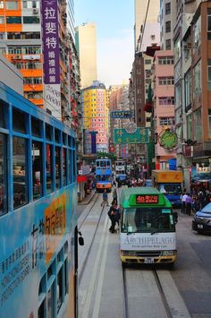 a city street filled with lots of traffic and tall buildings