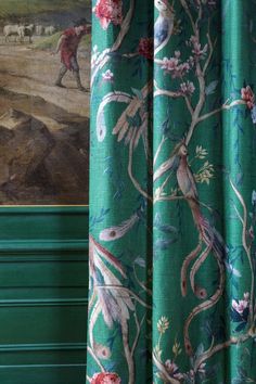 a green curtain with an animal painting on it