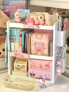 an assortment of stationery items are displayed on a shelf in a room with stuffed animals