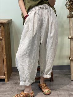 Stay cool and stylish in our Summer Solid 100% Linen Harem Pants. Crafted from breathable linen fabric, these pants offer a relaxed fit and effortless summer style. Perfect for casual outings or lounging at home, their versatile design ensures comfort without compromising on fashion. Relaxed Baggy Harem Pants For Spring, Comfortable White Spring Pants, White Comfortable Pants For Spring, Comfortable White Pants For Spring, Relaxed Spring Harem Pants, Ankle-length, Spring Relaxed Ankle-length Harem Pants, Relaxed Spring Ankle-length Harem Pants, Relaxed Ankle-length Harem Pants For Spring, Summer Beige Cotton Wide Leg Pants