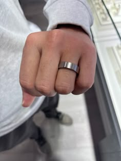 a close up of a person's hand with a ring on their thumb and fingers