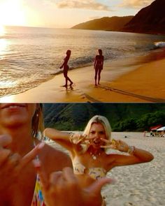 two women standing on top of a beach next to the ocean and one holding her hand up