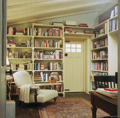 a room filled with lots of books and furniture