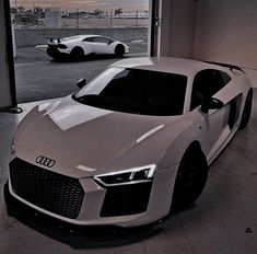 a white sports car parked in a garage