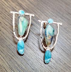 Add a pop of color to your ensemble with these Colorado Earrings. Handcrafted with precious sterling silver and gleaming turquoise colored stones, these unique accessories will bring a touch of fun to any outfit and add an air of sophistication to any occasion. Treat yourself today. Measures 1.3 inches tall x .8 inch wide. Unique, classy, pretty. For dress-up or everyday blue jeans. Metal post backing. Free shipping, 7-18 days delivery. Unique Blue Sterling Silver Earrings, Turquoise Sterling Silver Jewelry With Matching Earrings, Sterling Silver Turquoise Jewelry With Matching Earrings, Unique Metal Gemstone Earrings, Unique Metal Earrings With Gemstone, Unique Gemstone Metal Earrings, Artisan Turquoise Pierced Earrings, Unique Turquoise Metal Earrings, Turquoise Sterling Silver Earrings With Ear Wire