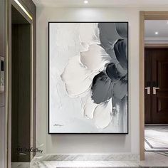 an abstract painting hangs on the wall in a modern style room with marble flooring