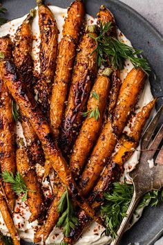 roasted carrots on a plate with herbs