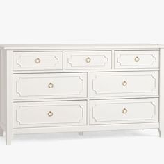 a white dresser with gold handles and drawers on it's sides, against a white background