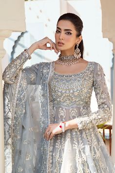 Bridal Gown Lehenga and Dupatta Pakistani Wedding Dress is an embellished masterpiece that will give the gorgeous bride a head-turning flawless look on the most important day of her life. Lavish designs and premium quality fabric make this Lehenga Dress an epitome of beauty. Pakistani Bridal Gown: Pakistani Bridal Gown has an alluring blue grey shade and is beautifully adorned with shimmering embellishments. Resham, dabka, crystals, sequins, and pearls enhance the glamour of this Pakistani Bridal Outfit. The Gown is fully embellished with intricate designs and silverwork. Bridal Lehenga: Pakistani Bridal Gown is paired with a huge flared Lehenga. Ruffles around the borders and premium organza give a perfect finishing to this gorgeous Lehenga. Ruffles enhance the charm and give a head-turni Gown Pakistani, Bridal Lehenga Pakistani, Gown Lehenga, Gorgeous Lehenga, Lehenga Pakistani, Pakistani Bridal Lehenga, Flared Lehenga, Lehenga Dress, Pakistani Bridal Dress