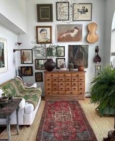 a living room filled with furniture and lots of pictures on the wall above it's coffee table