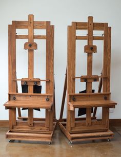 two wooden chairs sitting next to each other